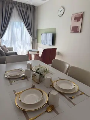 a living room with a table with plates on it at The Horizon Ipoh by Amris in Ipoh