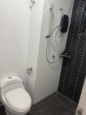 a bathroom with a toilet and a shower at The Horizon Ipoh by Amris in Ipoh
