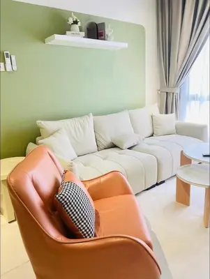 a living room with a couch and a chair at The Horizon Ipoh by Amris in Ipoh
