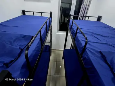 two bunk beds with blue sheets in a room at Marvel Nest- 3bedroom-Poolview-10pax in Bukit Mertajam