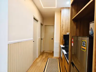 a small kitchen with a refrigerator and a hallway at DG HomestayMuslim Piccadilly Ipoh Pool View in Ipoh