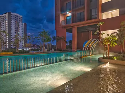 a swimming pool in front of a building at night at DG HomestayMuslim Piccadilly Ipoh Pool View in Ipoh