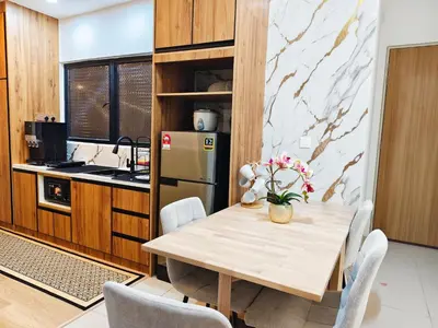 a kitchen with a wooden table and a refrigerator at DG HomestayMuslim Piccadilly Ipoh Pool View in Ipoh