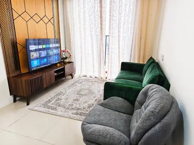 a living room with a couch and a television at DG HomestayMuslim Piccadilly Ipoh Pool View in Ipoh