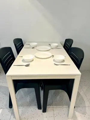 a white table with four chairs and plates on it at Casa for 8 ipoh Central Pet Allowed in Ipoh