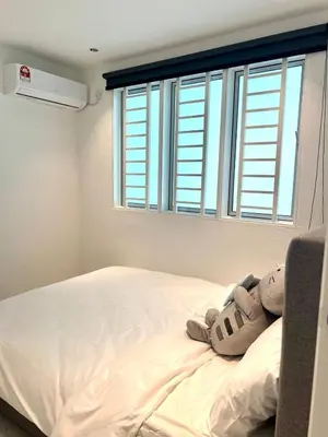 a bedroom with a bed with a stuffed animal on it at Casa for 8 ipoh Central Pet Allowed in Ipoh