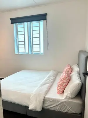 a bed with two pillows on it with a window at Casa for 8 ipoh Central Pet Allowed in Ipoh