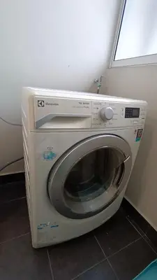 a washing machine in a room with a window at Straits Garden Penang 2BR in Jelutong