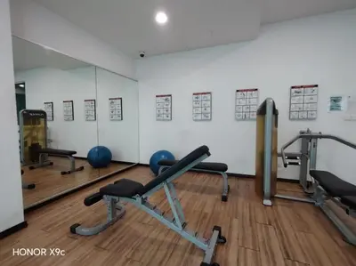 a gym with several exercise equipment in a room at Straits Garden Penang 2BR in Jelutong