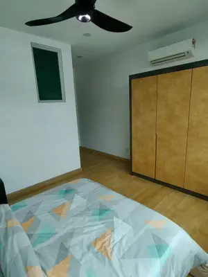 an empty room with a ceiling fan and a bed at Lakeside house in Gua Sai