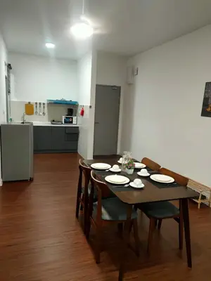 a table and chairs in a room with a kitchen at Shahiqa Palas Horizon Residence in Cameron Highlands