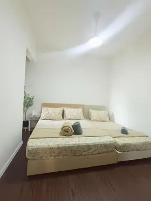 a white bedroom with a large bed in a room at Shahiqa Palas Horizon Residence in Cameron Highlands