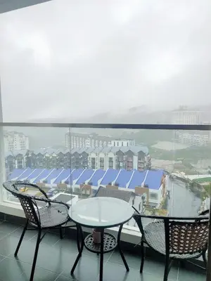 a table and chairs on a balcony with a view at Shahiqa Palas Horizon Residence in Cameron Highlands