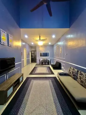 a living room with a couch and a ceiling fan at restu ibu homestay hillpark sp in Sungai Petani
