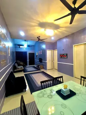 a living room with a table and a ceiling fan at restu ibu homestay hillpark sp in Sungai Petani