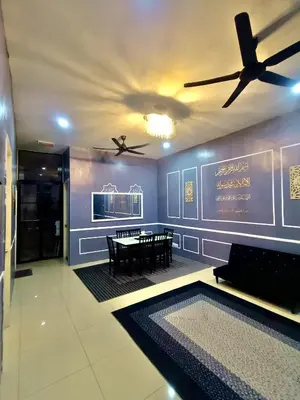 a dining room with a table and a ceiling fan at restu ibu homestay hillpark sp in Sungai Petani