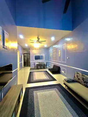 a living room with a couch and a table at restu ibu homestay hillpark sp in Sungai Petani