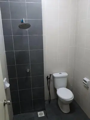 a bathroom with a toilet and a shower at restu ibu homestay hillpark sp in Sungai Petani