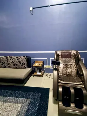 a living room with a couch and a chair at restu ibu homestay hillpark sp in Sungai Petani