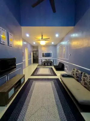 a living room with a couch and a table at restu ibu homestay hillpark sp in Sungai Petani