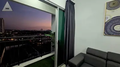 a room with a balcony with a view of a city at ModernNest-V1-PS5-sleep10 in Bukit Mertajam
