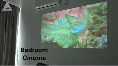 a green and blue lizard is on a television screen at ModernNest-V1-PS5-sleep10 in Bukit Mertajam