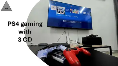 a video game controller sitting on a couch in front of a tv at ModernNest-V1-PS5-sleep10 in Bukit Mertajam