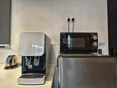 a coffee maker sitting on top of a refrigerator at Le Jardin Suite 8 Pax Sea View Infinity Pool in George Town