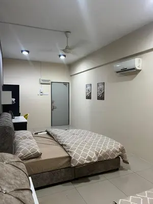a bedroom with a bed in a room at The Suncity Inn in Kampar