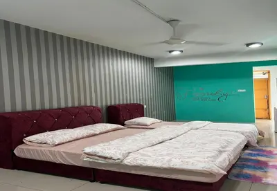 a bedroom with a large bed in a room at The Suncity Inn in Kampar