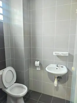 a bathroom with a toilet and a sink at The Suncity Inn in Kampar