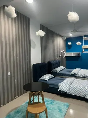 a bedroom with a bed and a table and clouds at The Suncity Inn in Kampar