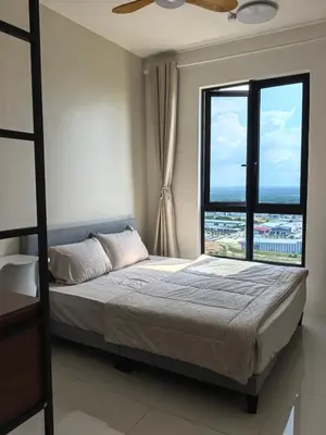 a bedroom with a bed and a large window at Batu Kawan Sunset Seaview Condo near Ikea & Design Village in Batu Kawan