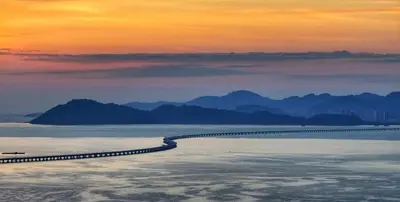 a road in the middle of the water at sunset at Batu Kawan Sunset Seaview Condo near Ikea & Design Village in Batu Kawan