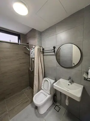 a bathroom with a toilet and a sink and a mirror at Batu Kawan Sunset Seaview Condo near Ikea & Design Village in Batu Kawan