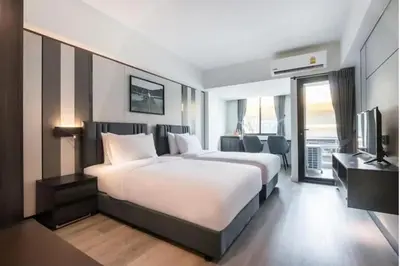a hotel room with a large bed and a television at Luna hotel in Gua Sai