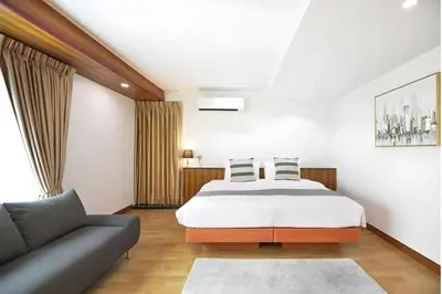 a bedroom with a bed and a couch at Luna hotel in Gua Sai