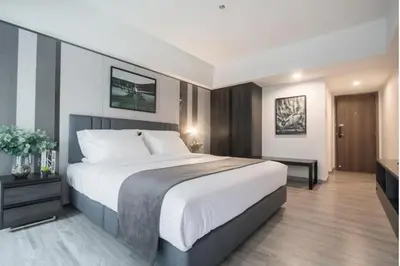 a bedroom with a large bed in a room at Luna hotel in Gua Sai