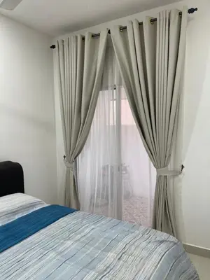 a bedroom with a bed and a window with curtains at Nafisa Homestay in Kepala Batas