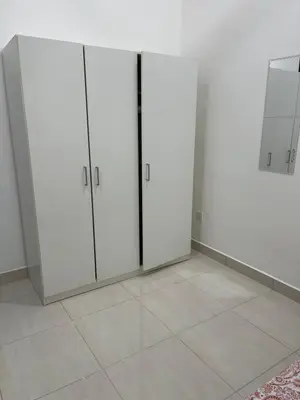 a room with white cabinets and a tile floor at Nafisa Homestay in Kepala Batas