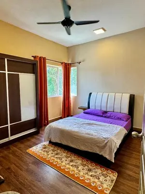 a bedroom with a bed and a ceiling fan at Ayaan Bliss Homestay at QuintetTanahRata in Cameron Highlands