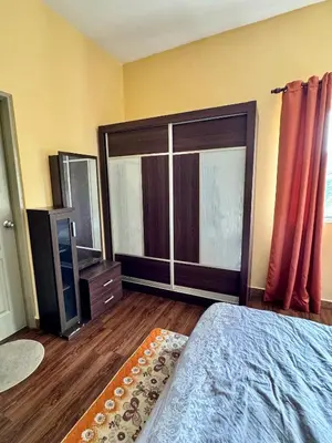 a bedroom with a bed and a large window at Ayaan Bliss Homestay at QuintetTanahRata in Cameron Highlands