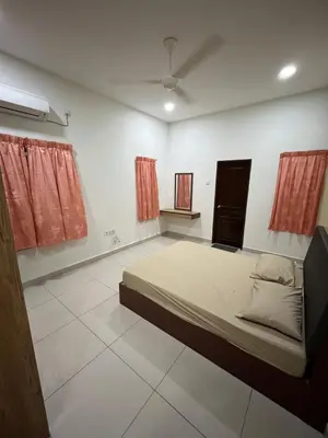 a bedroom with a large bed and red curtains at KK Homestay Ipoh in Ipoh