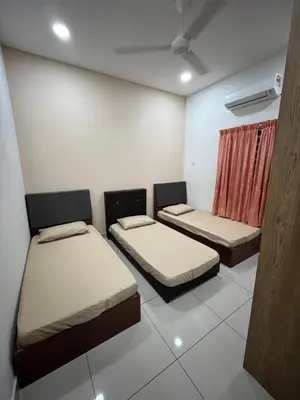 a room with two beds and a window at KK Homestay Ipoh in Ipoh