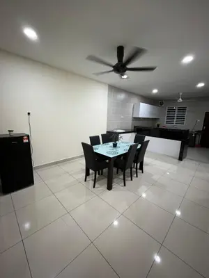 a dining room with a table and chairs and a ceiling fan at KK Homestay Ipoh in Ipoh