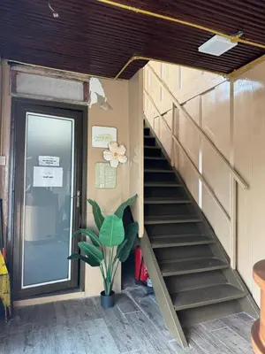 a staircase leading up to a building with a door at PadiBox Homestay in Sekincan