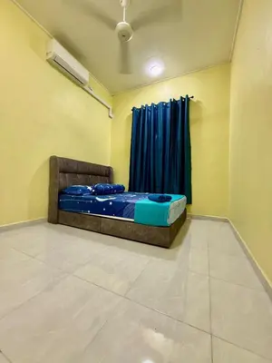 a bedroom with a bed and a window with blue curtains at Homestay Selesa KPP Guest House in Gua Sai
