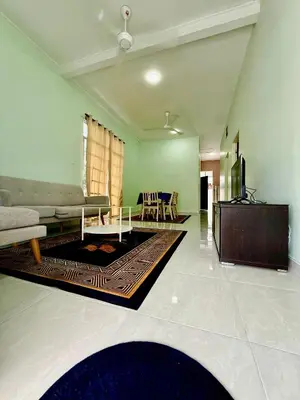 a living room with a couch and a table at Homestay Selesa KPP Guest House in Gua Sai