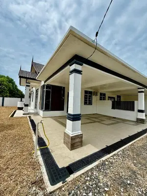 a small house with a large patio in front of it at Homestay Selesa KPP Guest House in Gua Sai