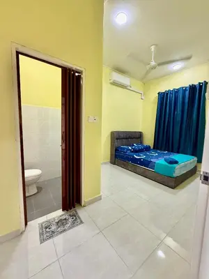 a room with a bed and a bathroom with a toilet at Homestay Selesa KPP Guest House in Gua Sai